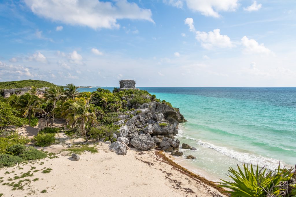 Caribbean beach with Mayan Ruins of Tulum on background - Tulum, Mexico