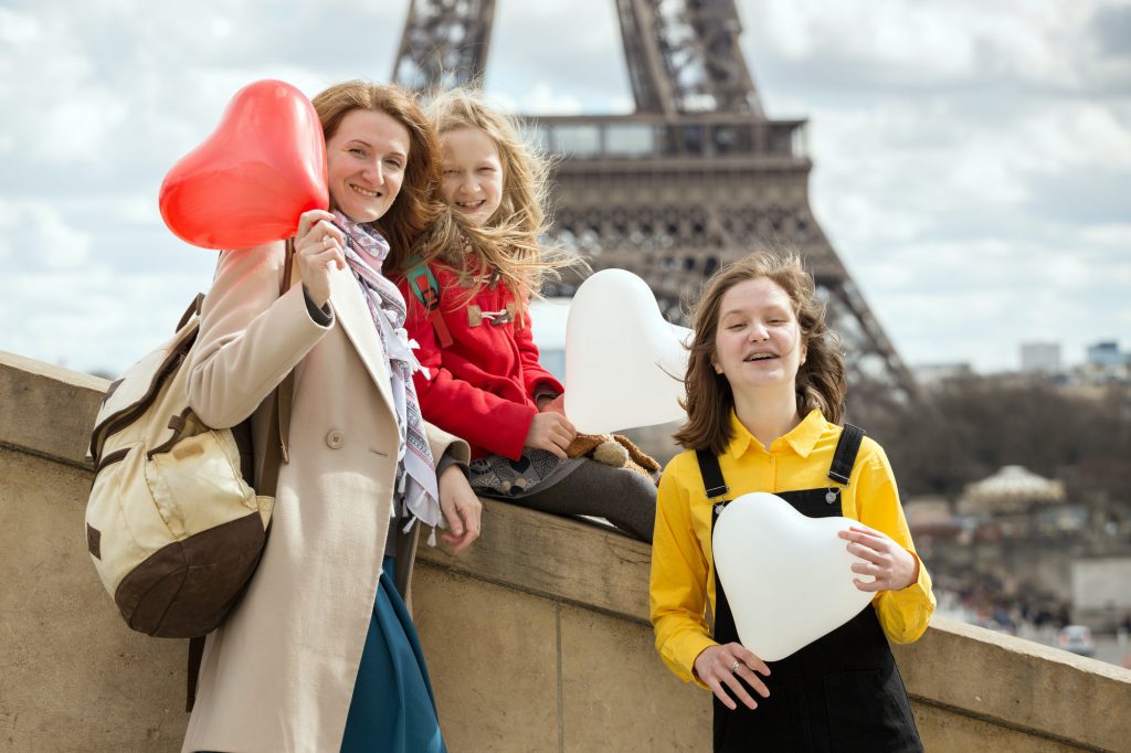 Mom and daughters on the background of the Eiffel Tower