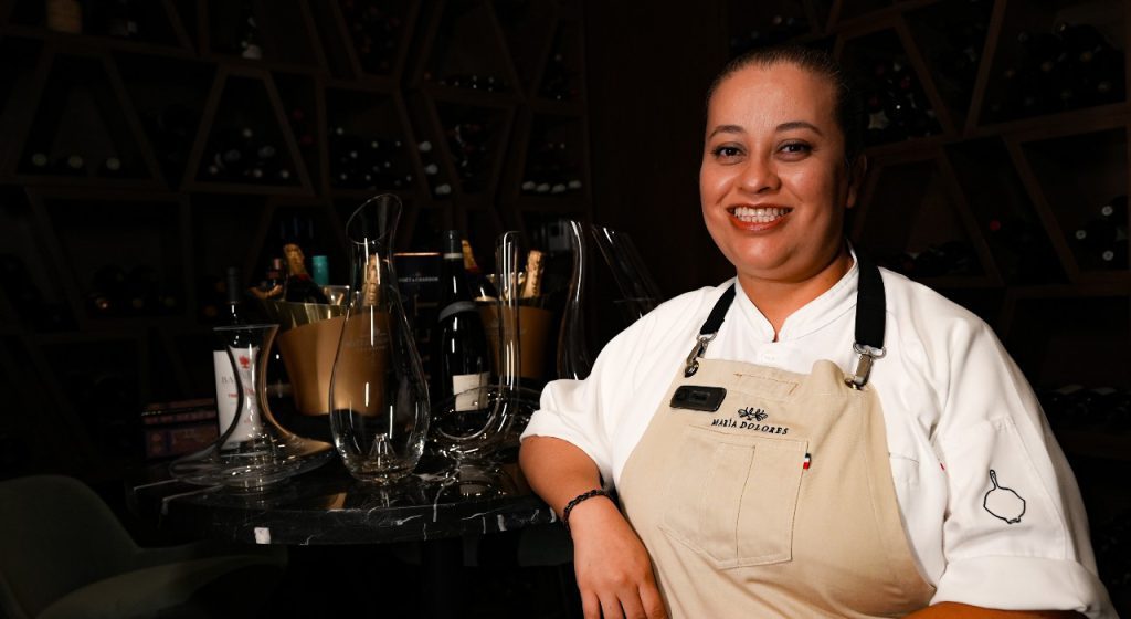 Member of María Dolores Staff posing in the acclaimed restaurant's cellar